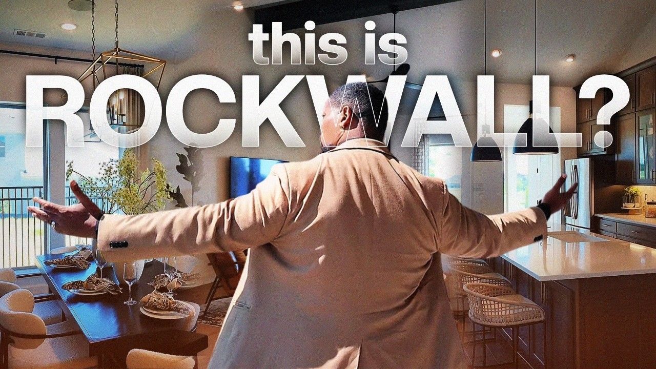 Man standing in a modern kitchen with arms outstretched; overlaid text reads “this is ROCKWALL?”
