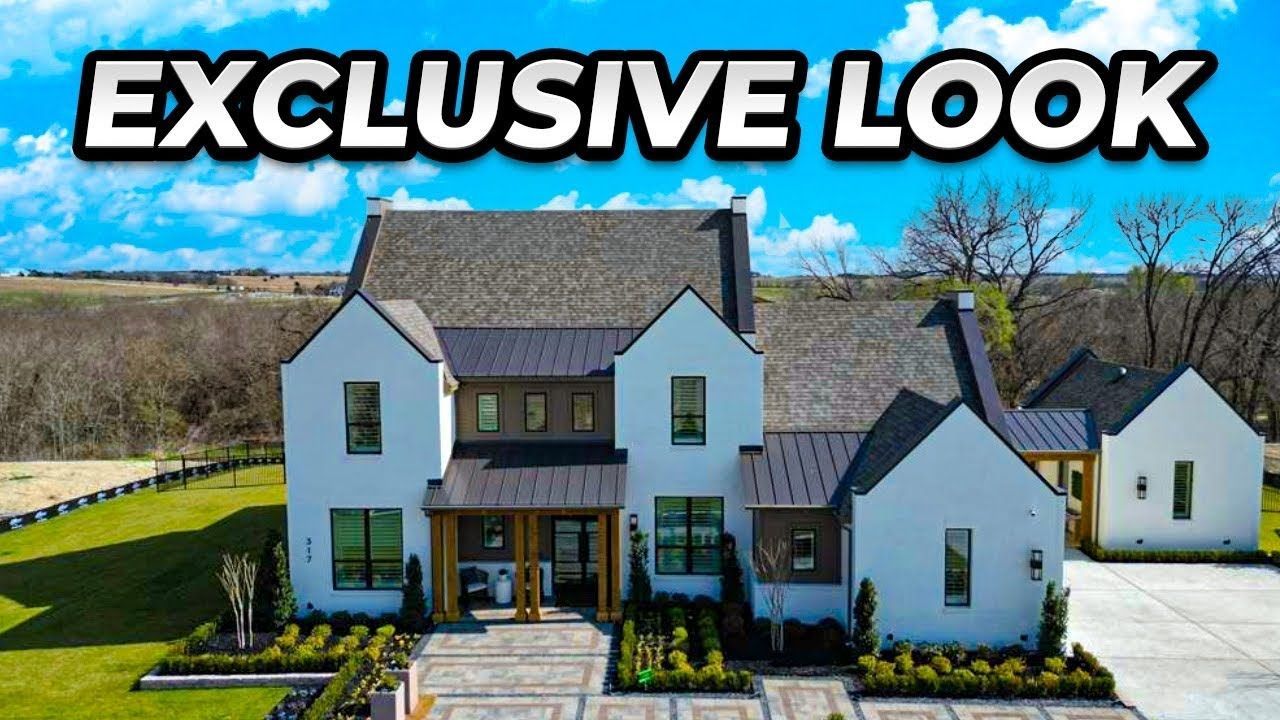 Modern two-story white house with dark roof and landscaped yard under an “EXCLUSIVE LOOK” headline