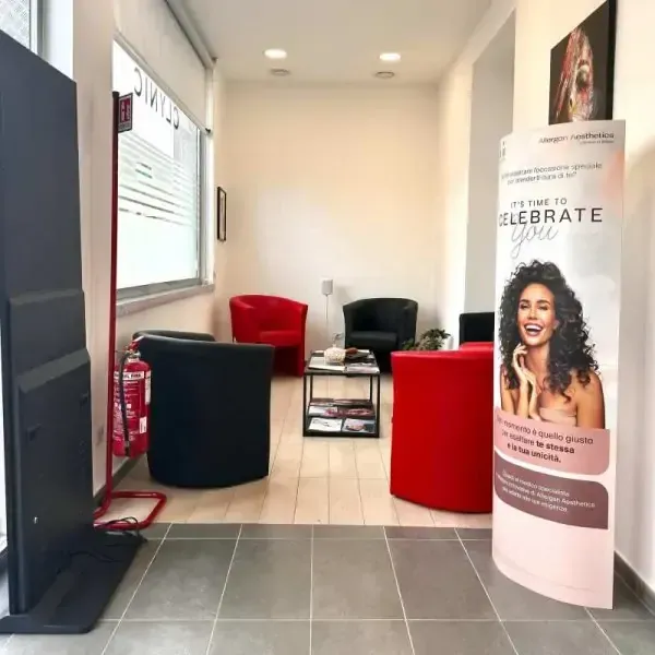 Una stanza con sedie e un cartello che dice festeggia gratis