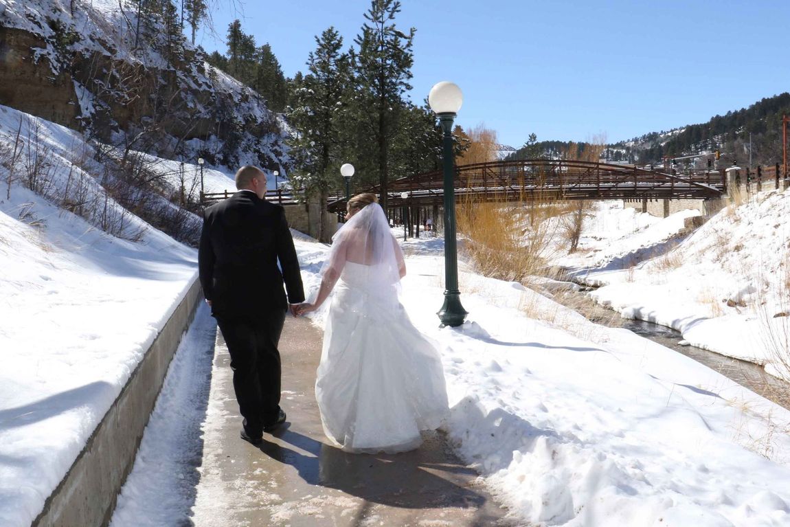 newlywed couple walking during snow season