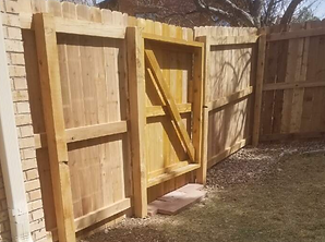 A wooden fence with a gate attached to it.