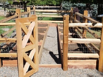A wooden fence with a gate in the middle of it is being built.