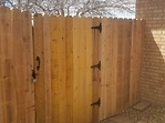 A wooden fence with a gate attached to it.