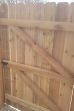 A close up of a wooden fence with a gate.