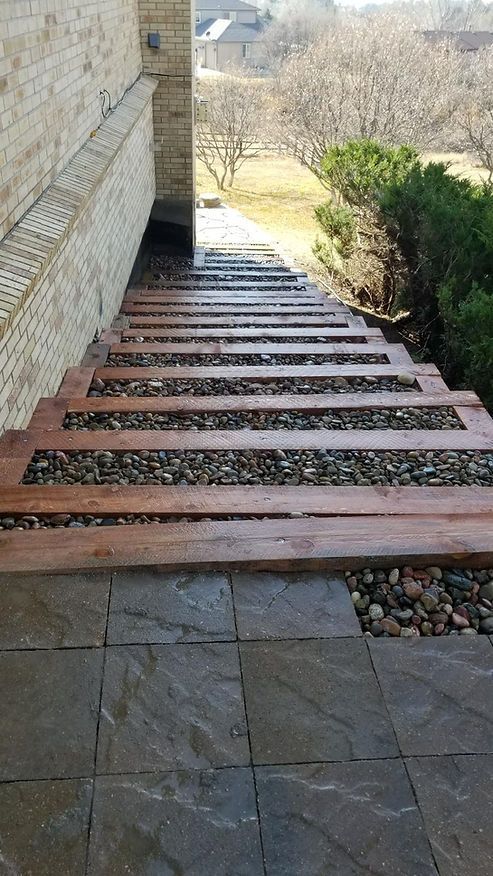 A set of wooden stairs leading up to a house.