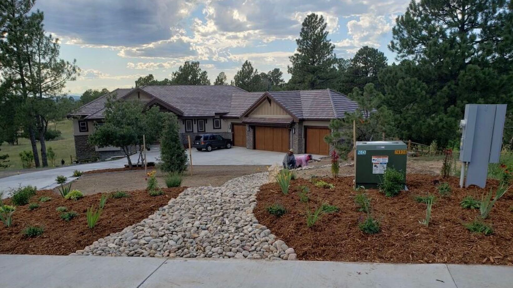 A large house with a car parked in front of it and a walkway leading to it.