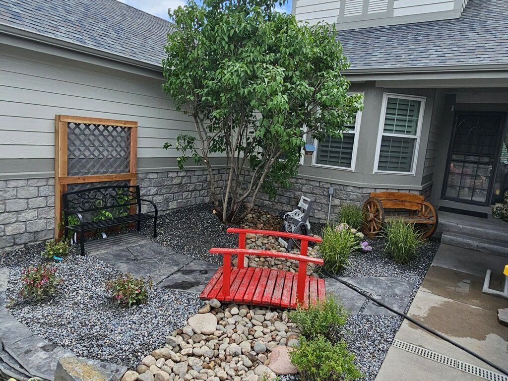 There is a small red bridge in the middle of the garden.