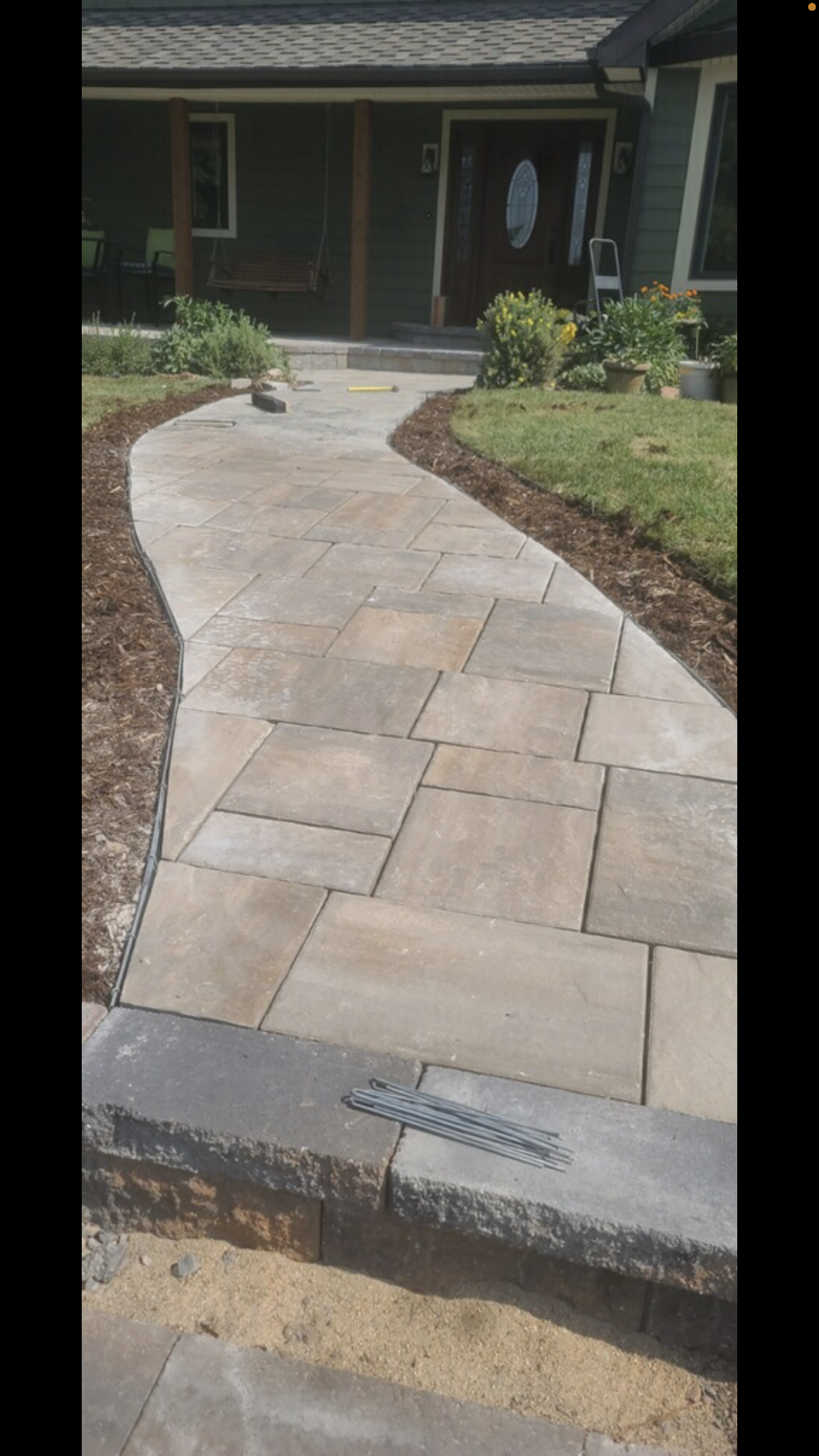 A walkway is being built in front of a house.