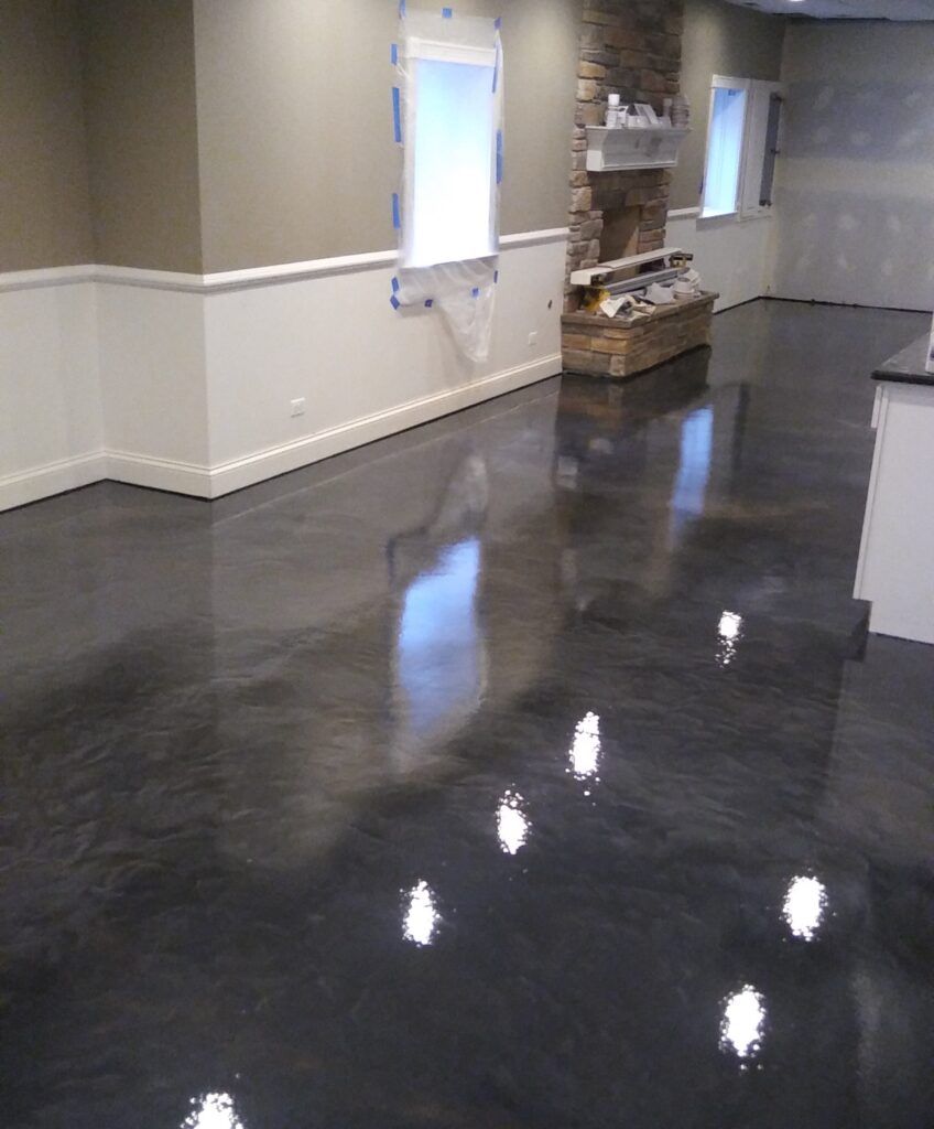 A living room with a black floor and a fireplace.