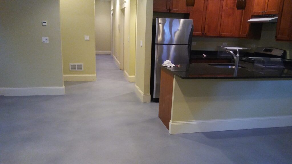 A kitchen with stainless steel appliances and a stainless steel refrigerator.