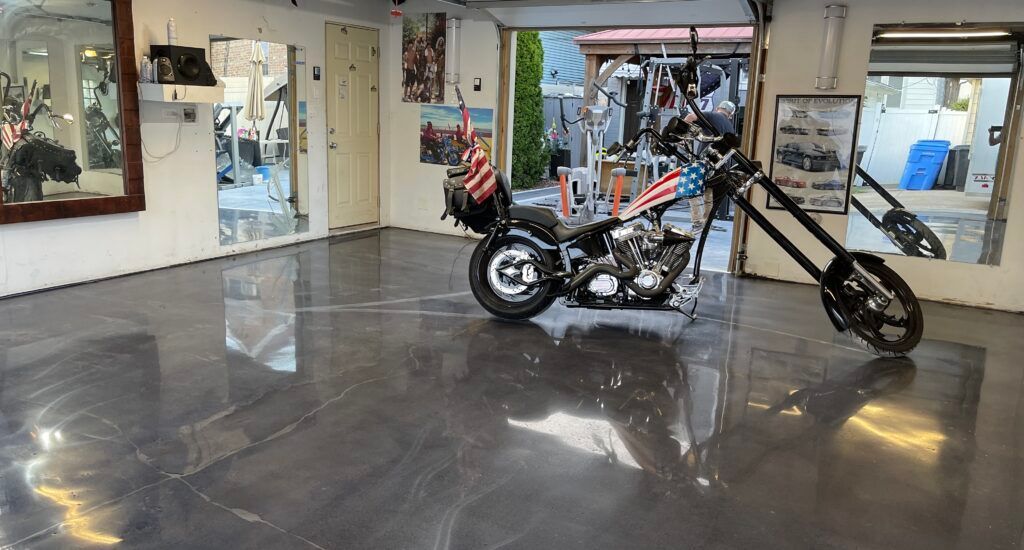 A motorcycle is parked on the floor of a garage.