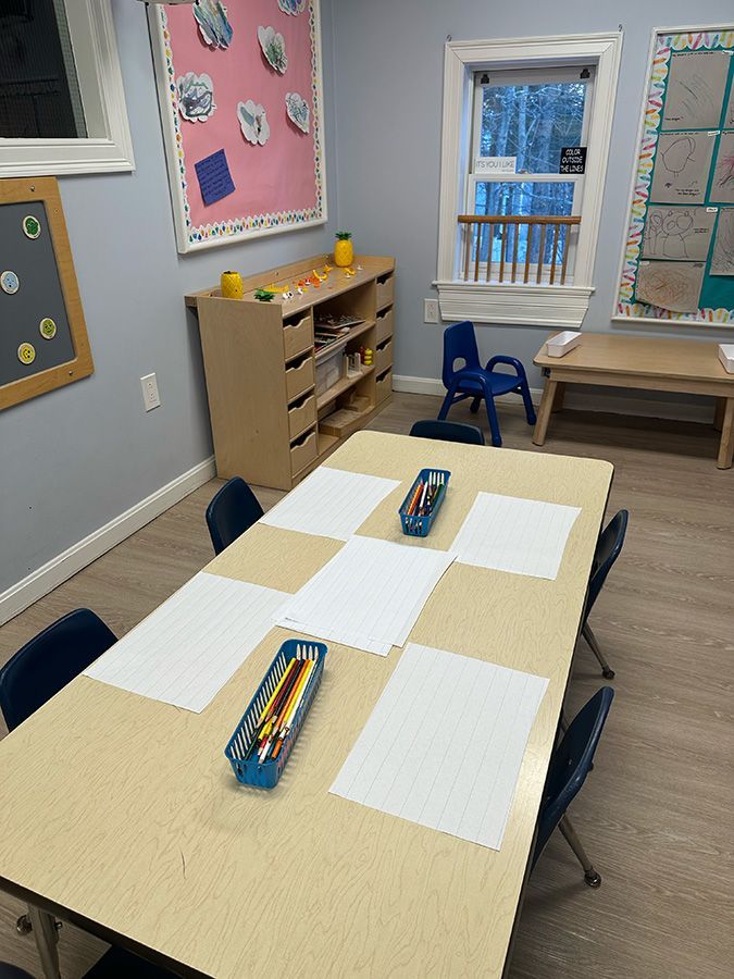 two kids are playing in barn yard child care center