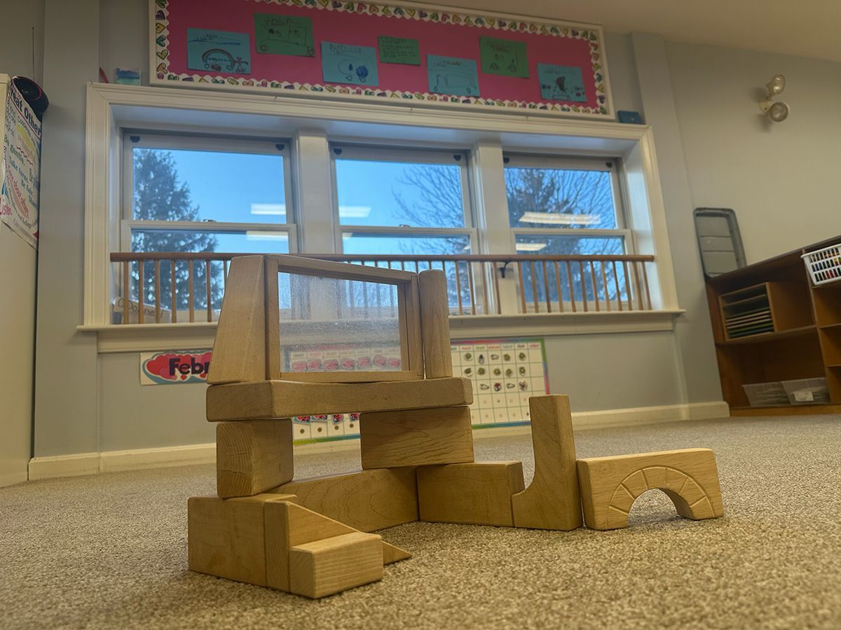 two kids are playing in barn yard child care center