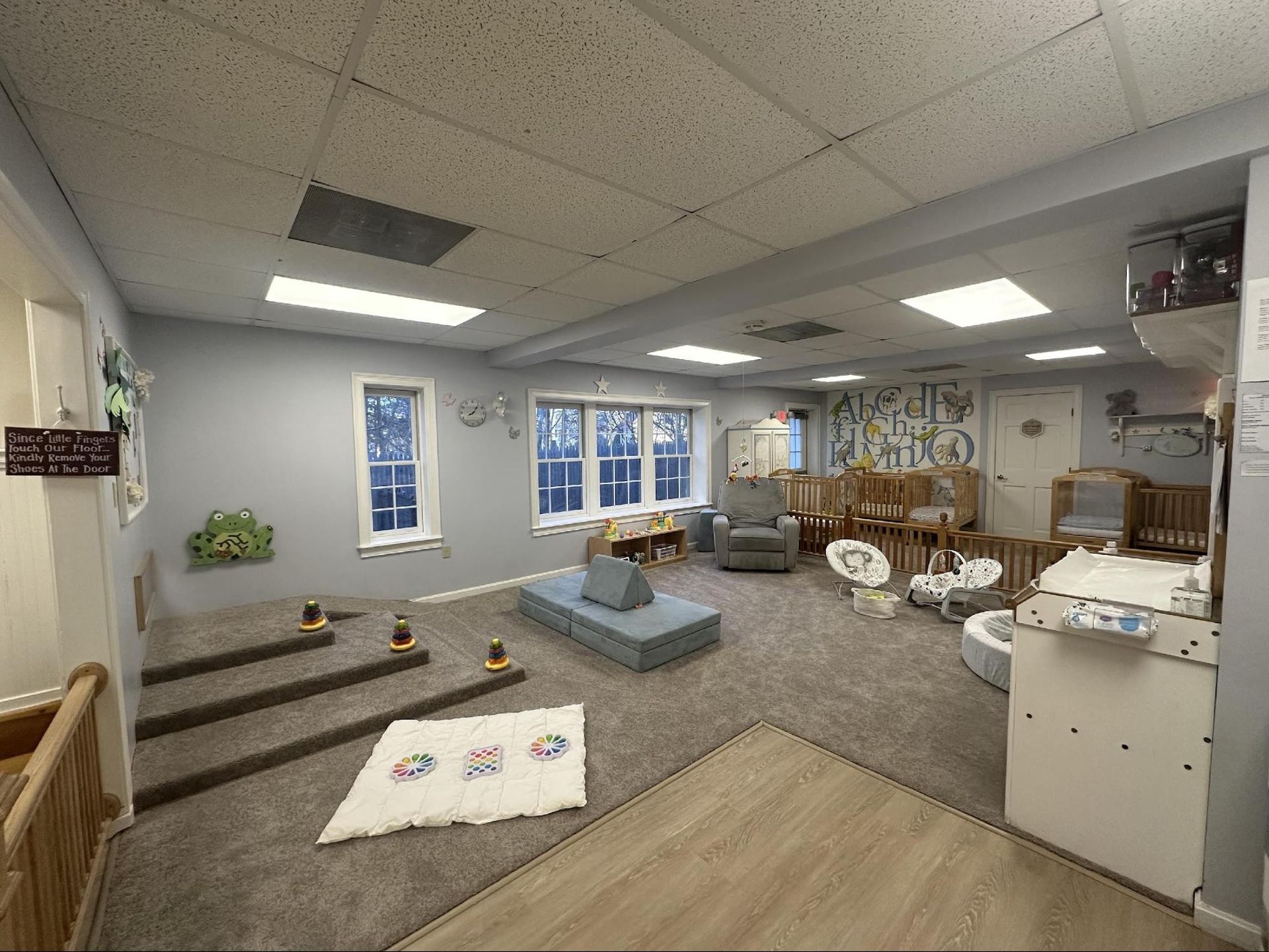 two kids are playing in barn yard child care center