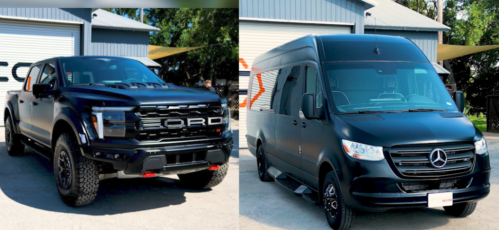 A black truck and a black van are parked next to each other.