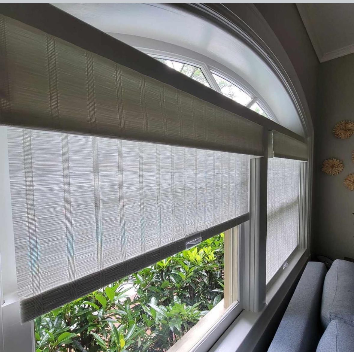 A living room with a large window and a couch