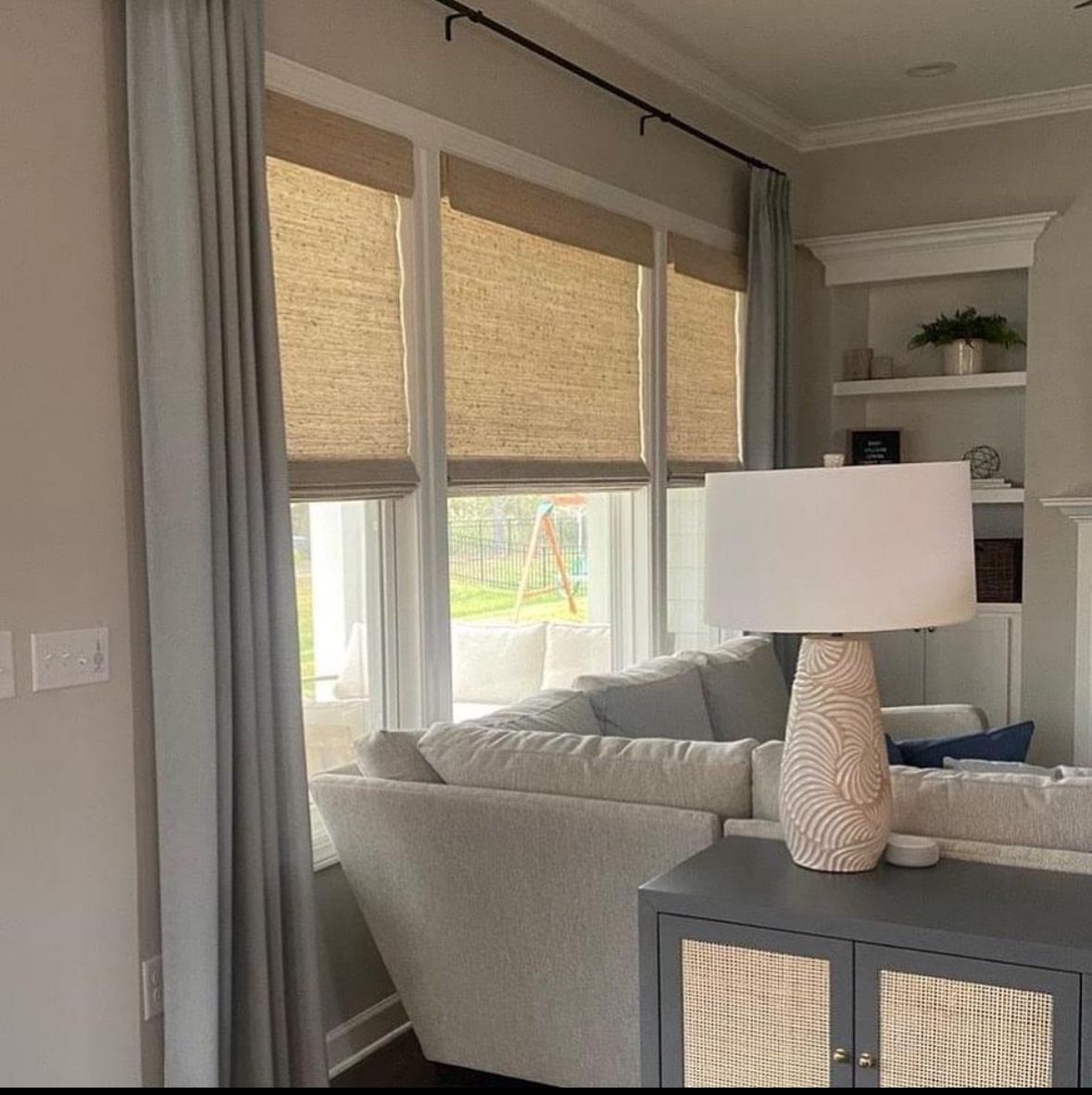 A living room with a couch and a lamp