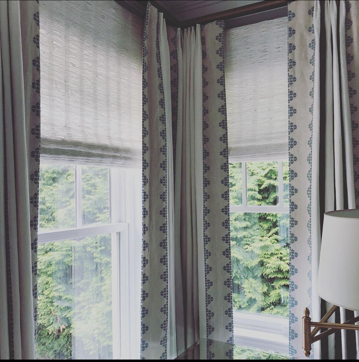 A room with a lot of windows and curtains