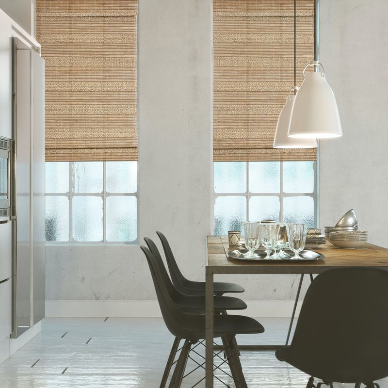 A dining room with a table and chairs in front of a window