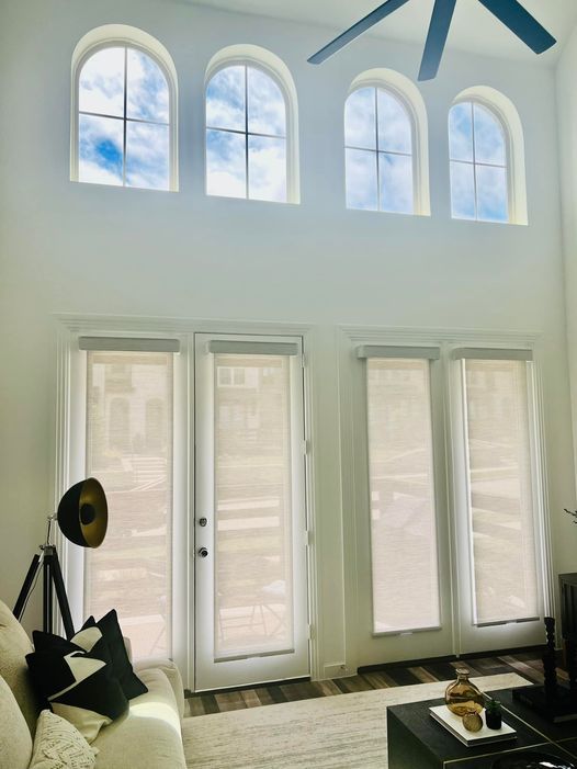 A window with three different shades of blinds on it.