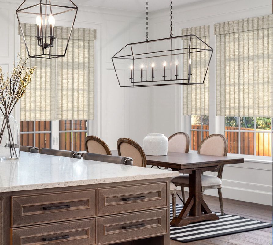 A dining room with a table and chairs and a chandelier hanging from the ceiling.