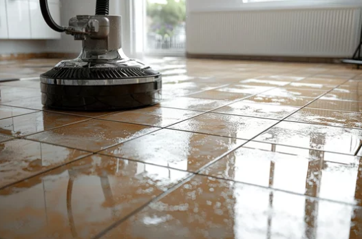 A tile floor is being cleaned with a machine.
