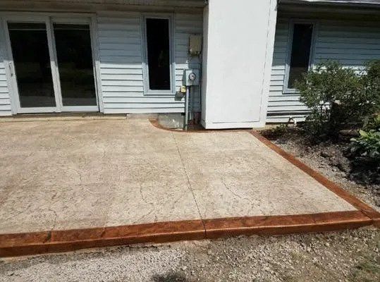 There is a concrete patio in front of a house