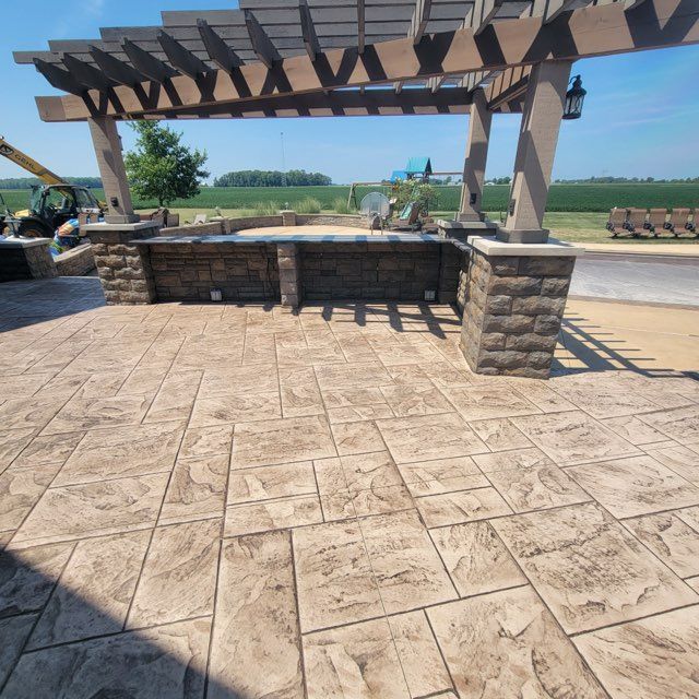 A patio with a wooden pergola over it