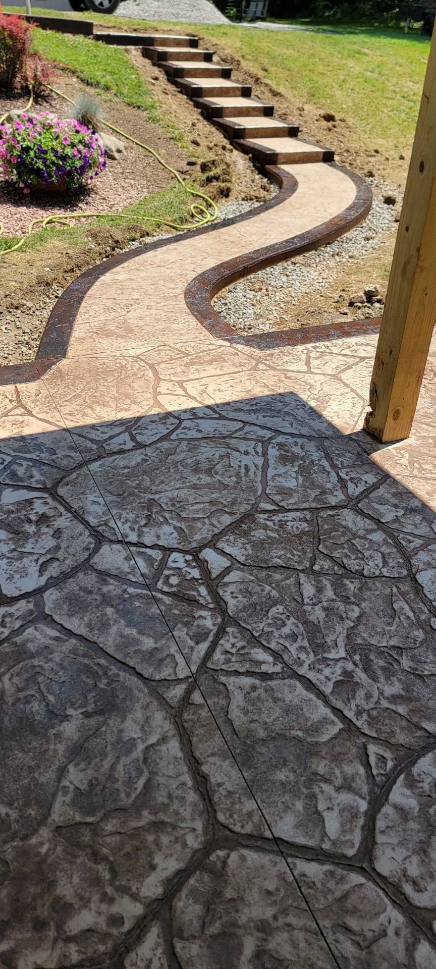 A concrete pathway with stairs leading up to a house
