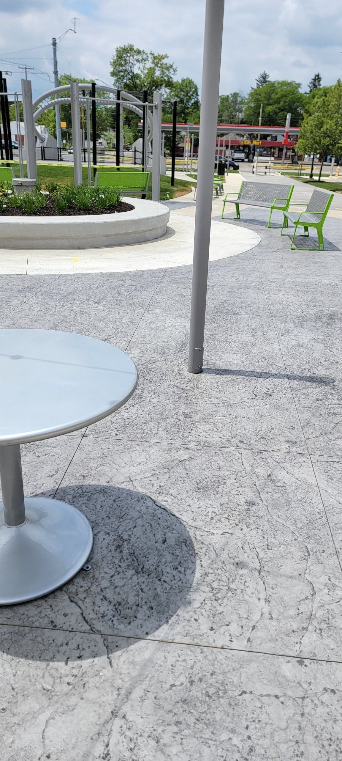 A round table is sitting in the middle of a park