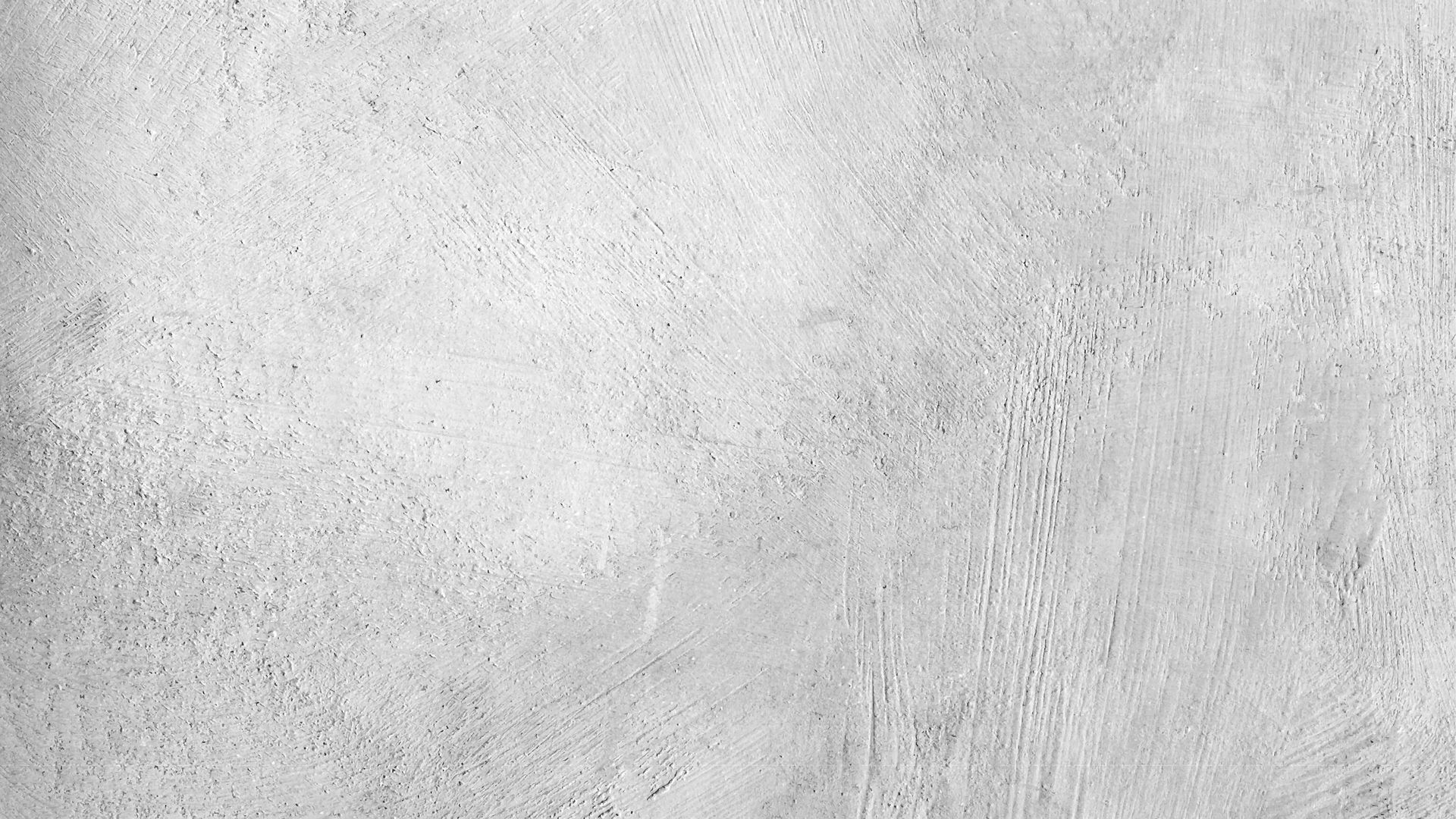 Close-up of textured concrete surface with brush strokes and rough patches.