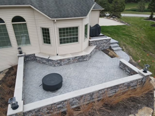 An aerial view of a house with a patio and stairs