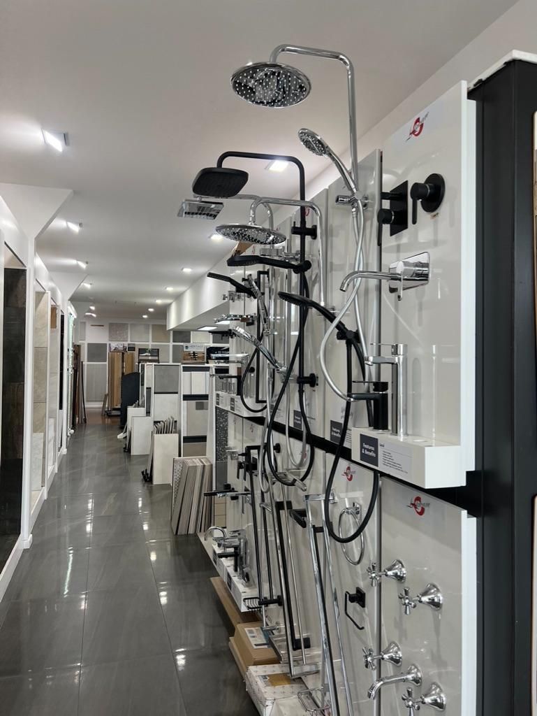 A Long Hallway Filled With Lots of Shower Heads and Faucets — Traditional Tiles & Flooring In Woree, QLD