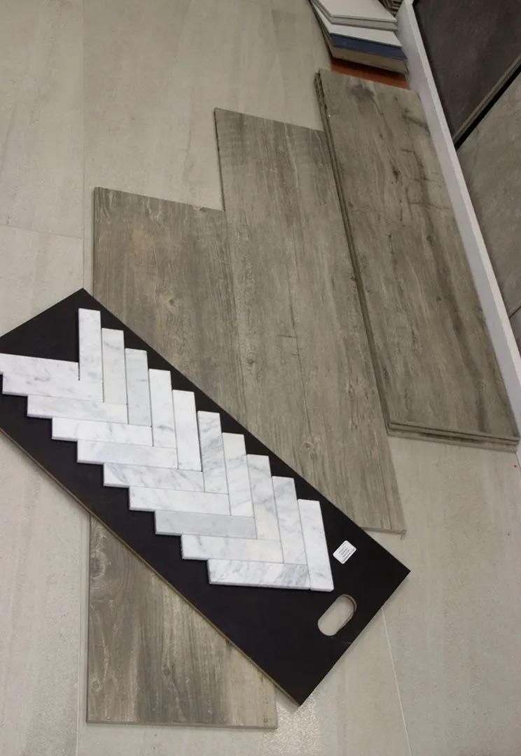 A Tray of Tiles Sitting on Top of a Wooden Floor — Traditional Tiles & Flooring In Douglas Shire, QLD