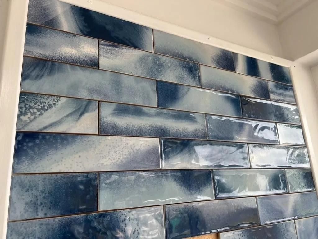 A Wall With a Lot of Blue Tiles on It — Traditional Tiles & Flooring in Port Douglas, QLD