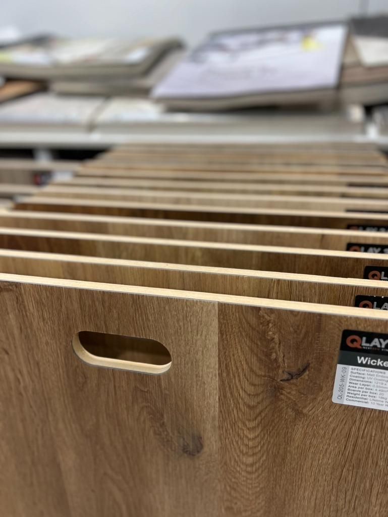 A Row of Wooden Boards With Handles in a Store — Traditional Tiles & Flooring In Woree, QLD