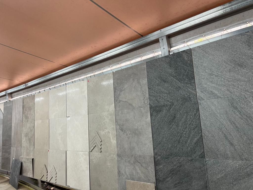 A Row of Tiles Are Lined Up on a Shelf in a Store — Traditional Tiles & Flooring In Cassowary Coast, QLD