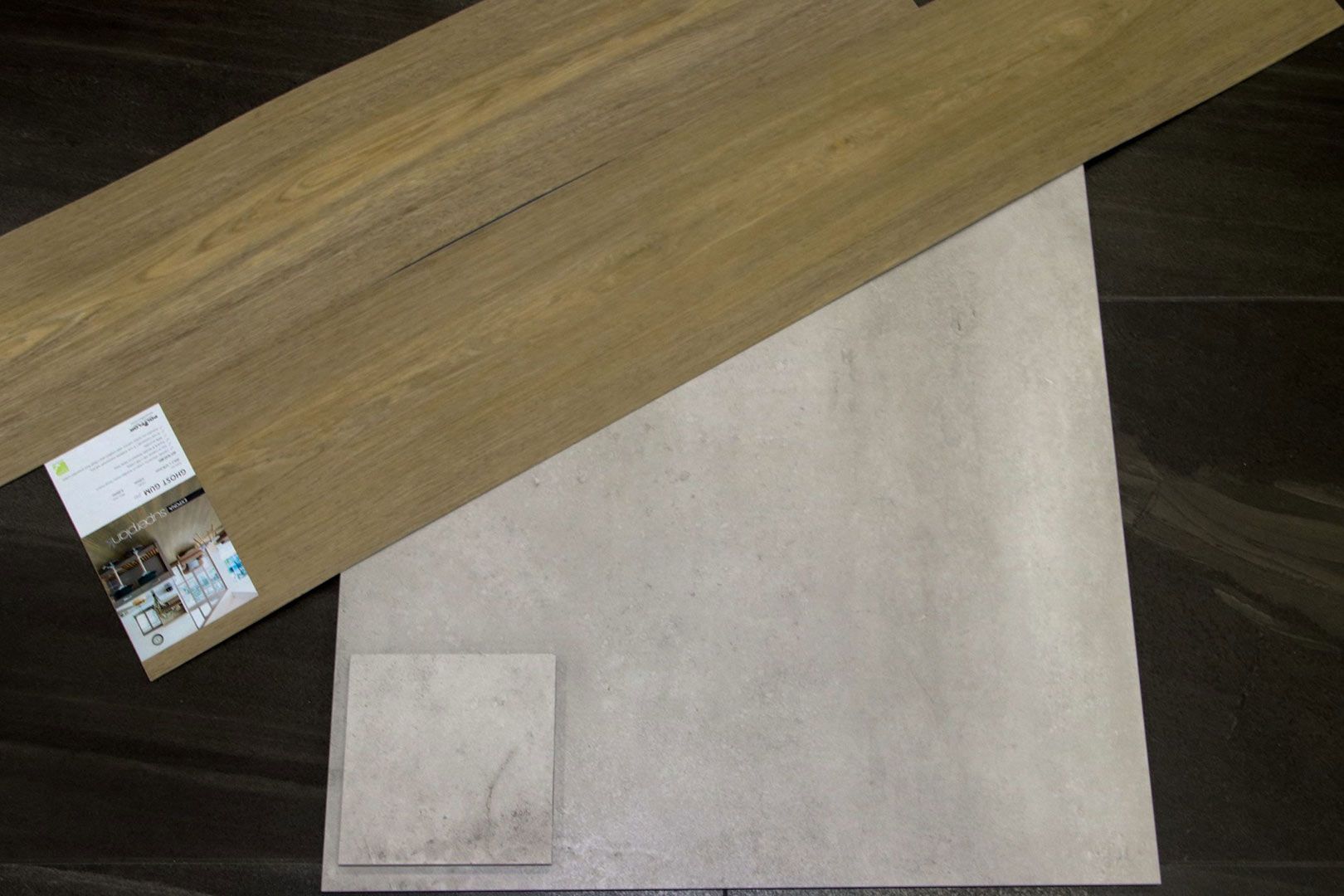 A Piece of Wood and A Piece of Tile Are on A Table — Traditional Tiles & Flooring In Woree, QLD