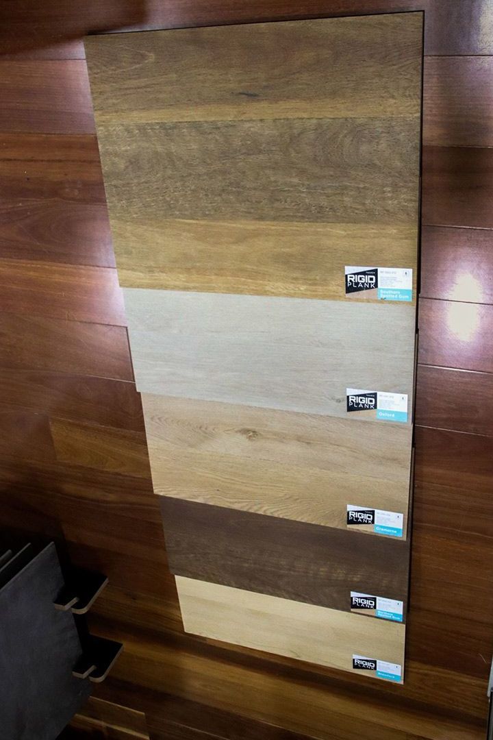 A Row of Wooden Boards Sitting on Top of A Wooden Floor — Traditional Tiles & Flooring In Woree, QLD