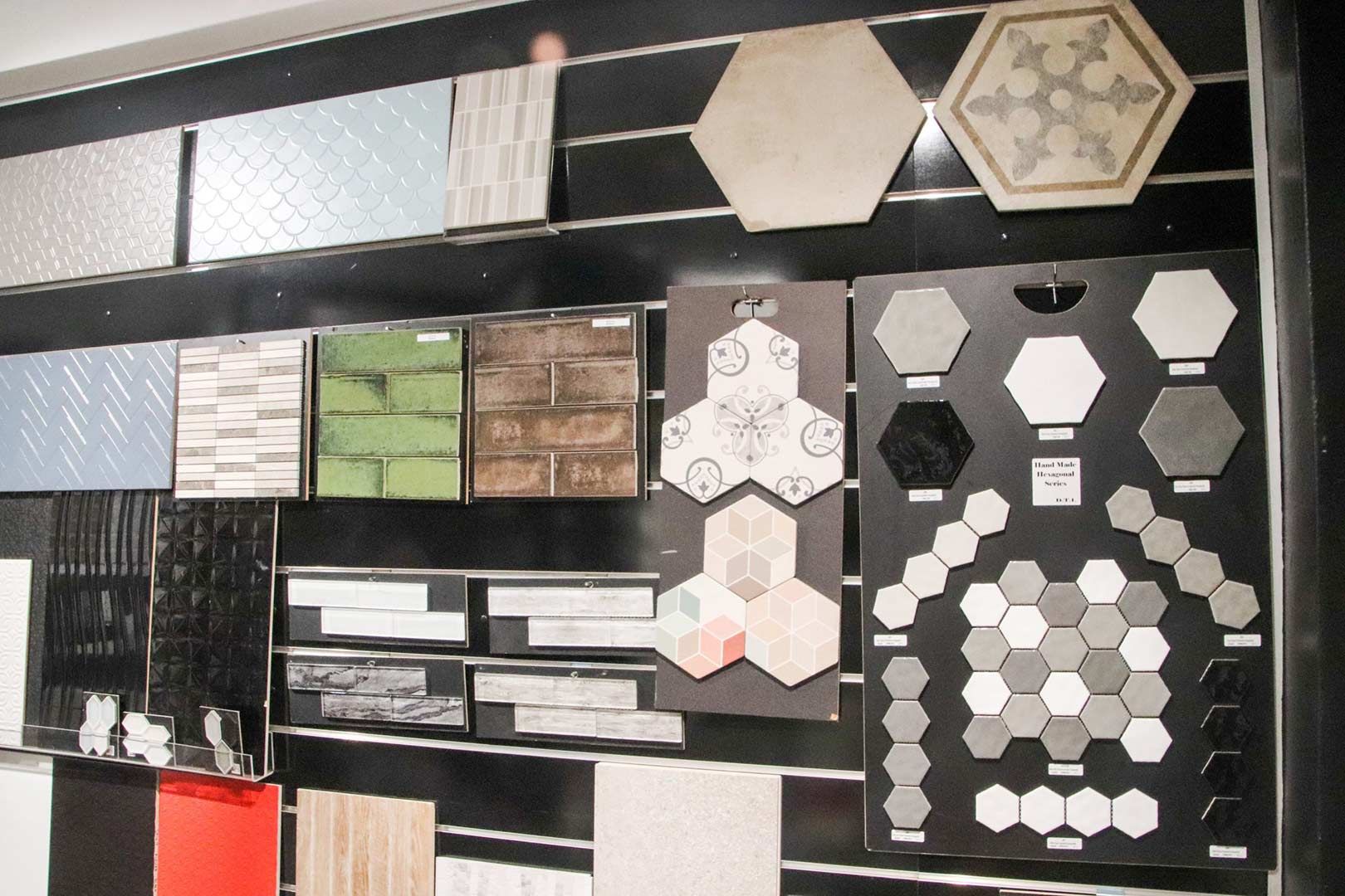 A Wall with A Variety of Tiles on It — Traditional Tiles & Flooring In Woree, QLD
