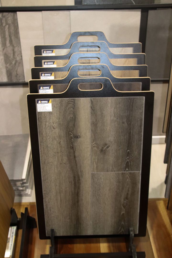 A Stack of Tiles Sitting on Top of Each Other on A Display Stand — Traditional Tiles & Flooring In Woree, QLD