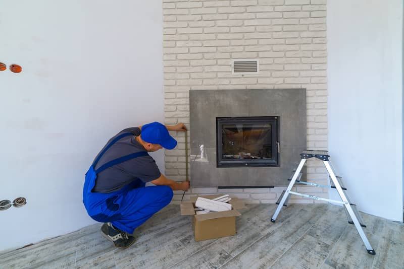 contactor measuring stucco fireplace