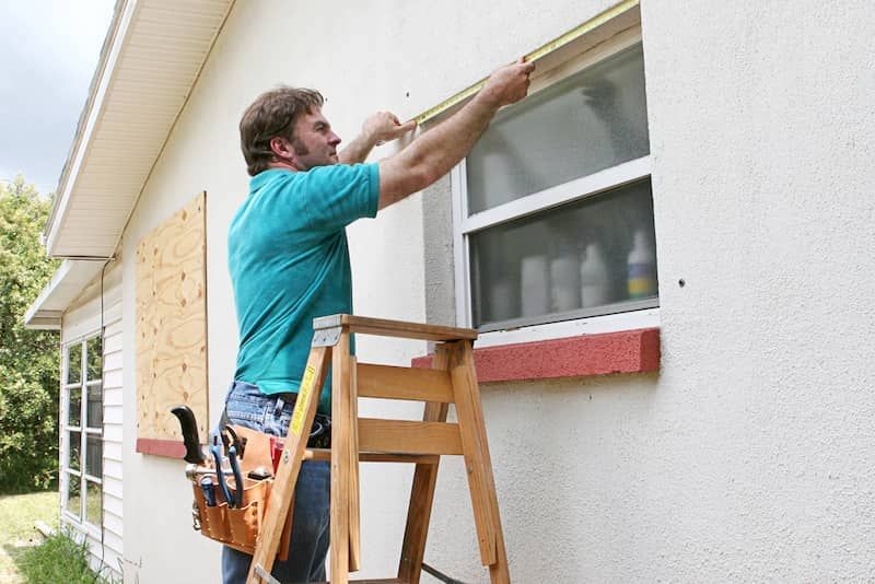 contractor measuring window stucco