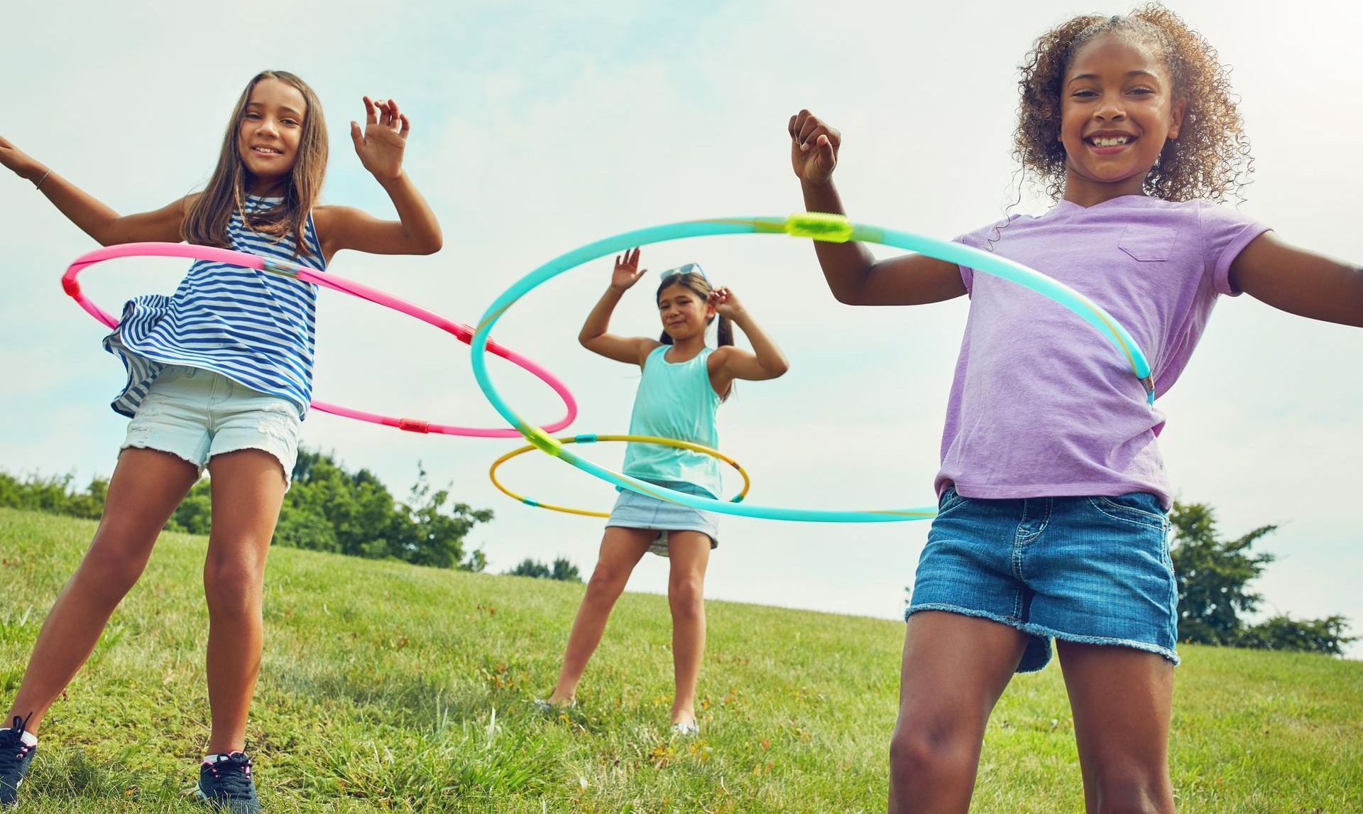 Children playing with hula hoops. Children playing with hula hoops.