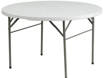 a white round folding table with metal legs on a white background .