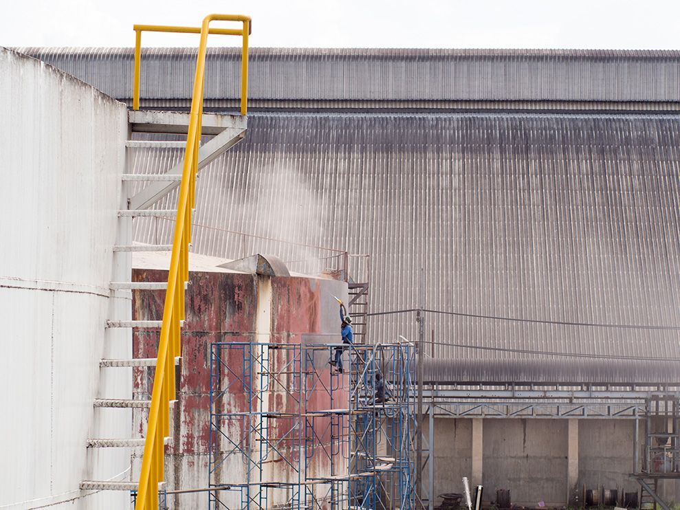 A yellow ladder is attached to the side of a building.