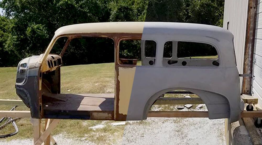 A car is sitting on a wooden stand in a field.