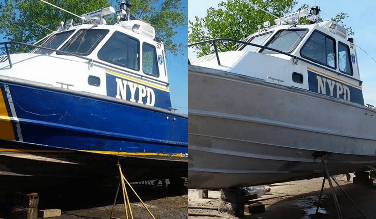 A blue and white boat with nypd written on the side is parked next to a white boat.