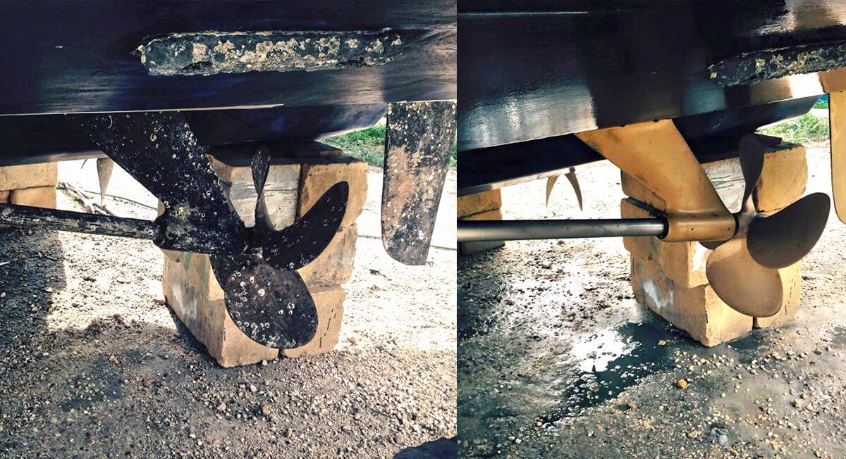 A boat propeller is sitting on a wooden block.