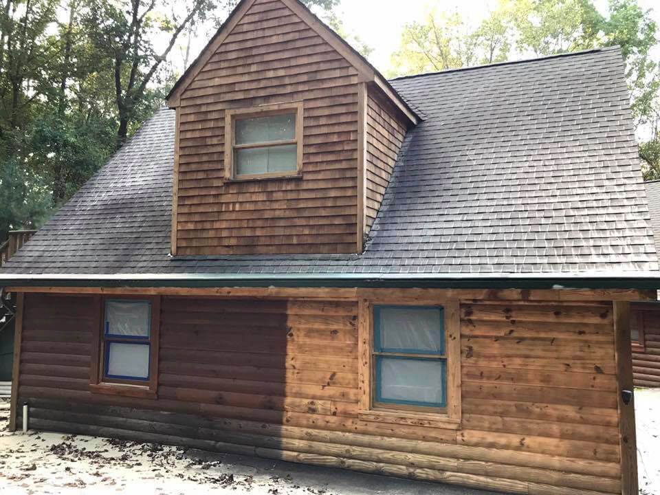 A log cabin with a roof that is covered in shingles.